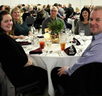 Employees at gala dinner sitting at a round table